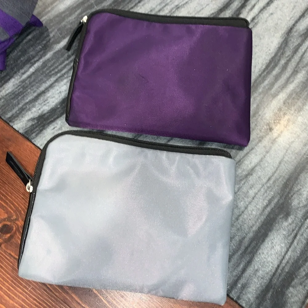 Tumi Purple and Gray Travel Pouches with Socks and sleep masks